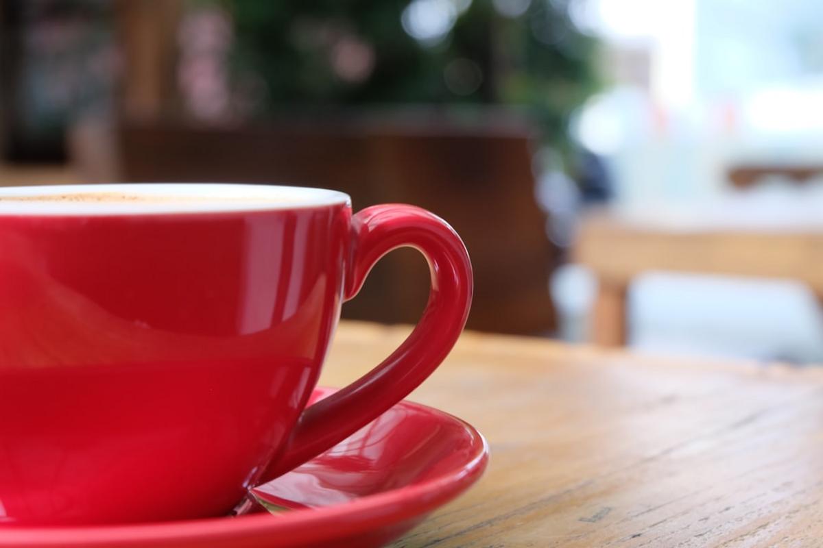 A vibrant Dutch coffee shop with modern decor and baristas preparing specialty drinks