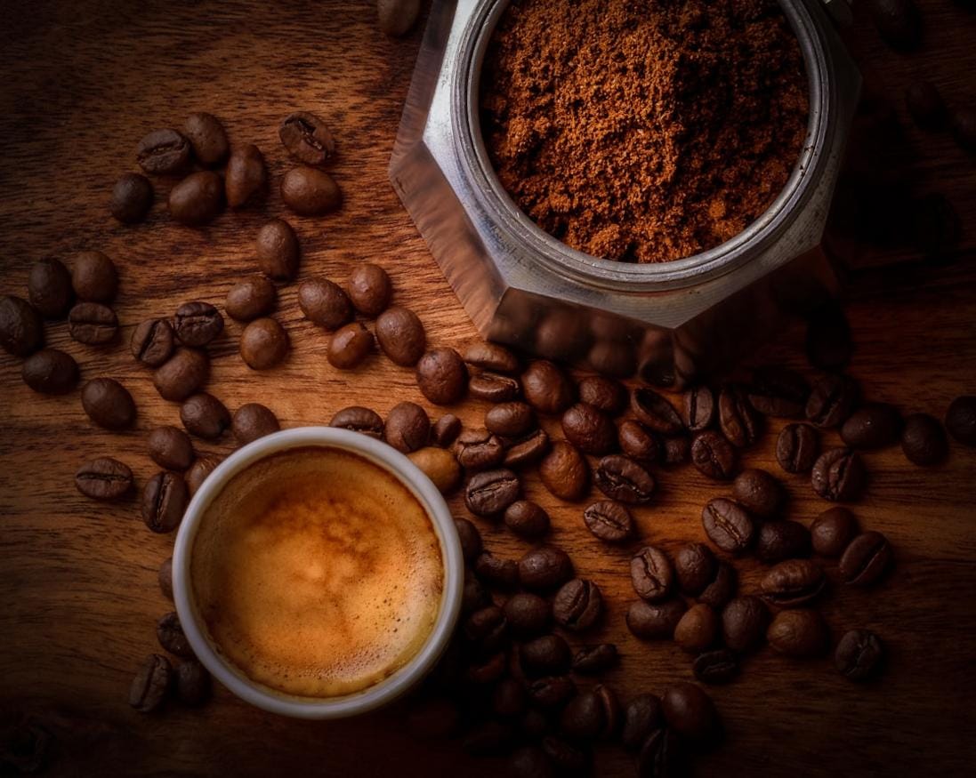 An image of a Dutch home coffee setup with pour-over equipment and beans arranged on a rustic table
