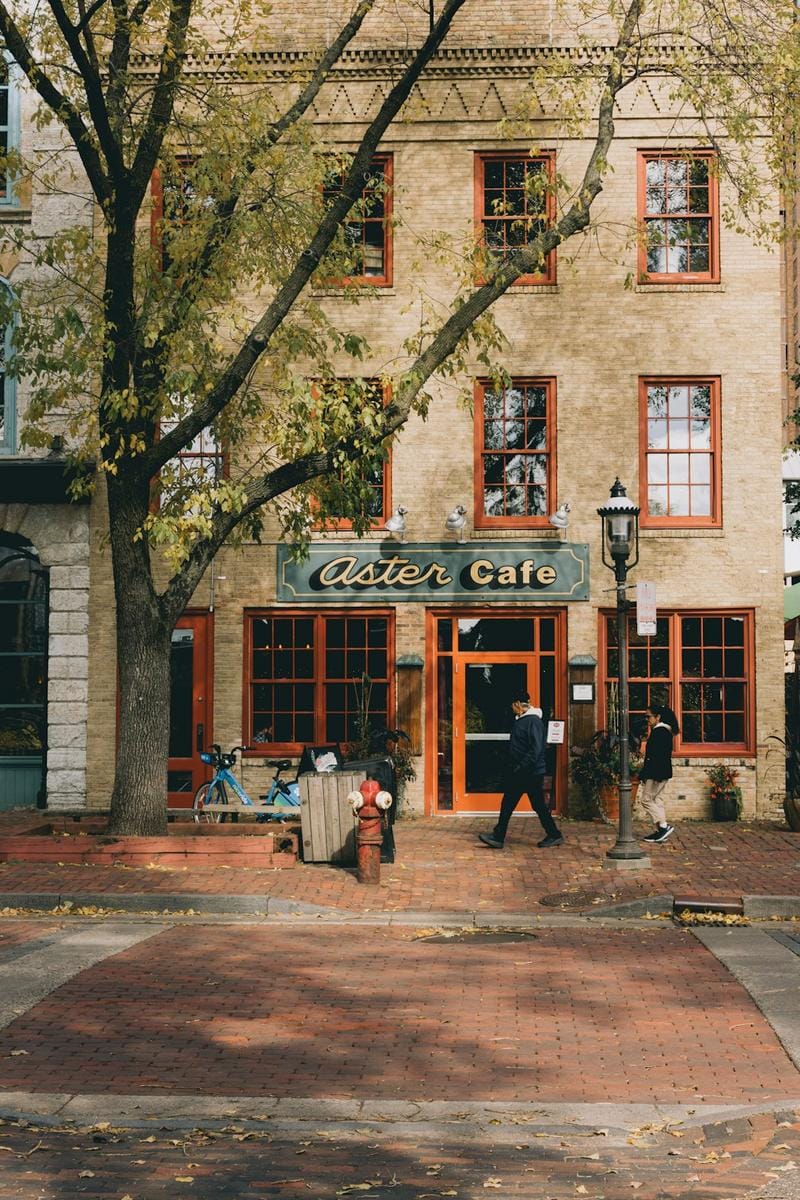 A cozy Dutch café with baristas preparing specialty coffee, showcasing a warm, inviting ambiance perfect for Sunday mornings