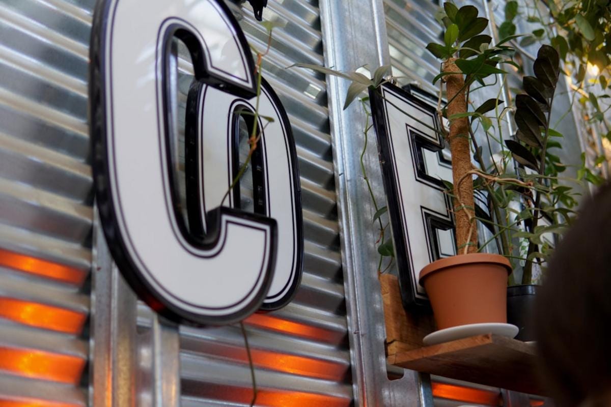 A bustling Dutch coffee festival with diverse vendors showcasing beans, brewing equipment, and innovative coffee concepts.